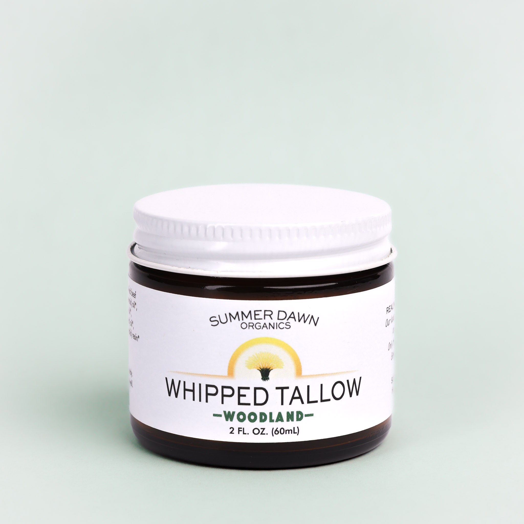 Jar of Summer Dawn Organics Whipped Tallow on a light green background